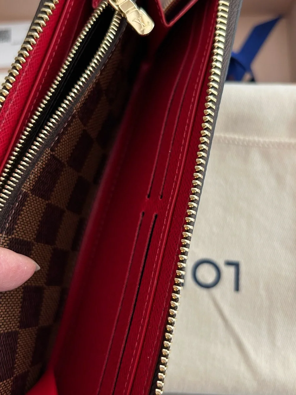 Authentic Louis Vuitton Damier Ebene Zip-Around Wallet with Red Leather Pull
